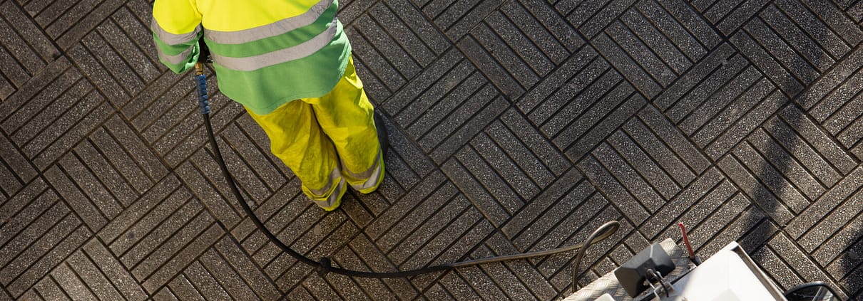 worker cleaning a street sidewalk