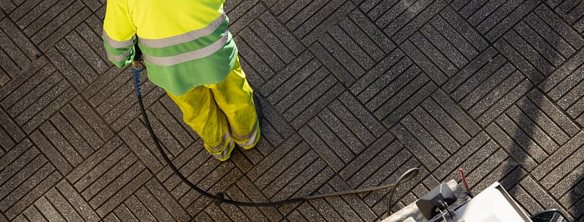 worker cleaning a street sidewalk